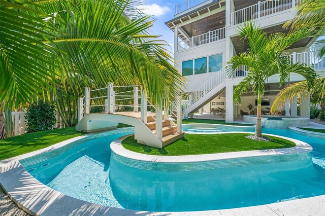 311 Spring Ave, Anna Maria, FL 34216 - view of pool with a pool with connected hot tub, a patio, stairway, and a yard