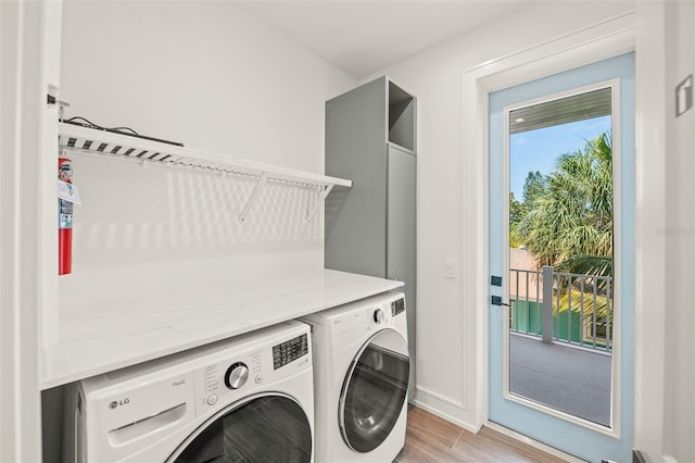311 Spring Ave, Anna Maria, FL 34216 - clothes washing area with light wood-style flooring, laundry area, and separate washer and dryer