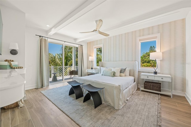 311 Spring Ave, Anna Maria, FL 34216 - bedroom with baseboards, access to exterior, light wood-type flooring, and beam ceiling