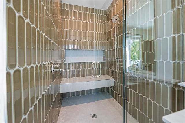 311 Spring Ave, Anna Maria, FL 34216 - bathroom with tile patterned floors, a tile shower, and tile walls