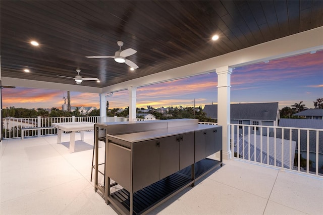 311 Spring Ave, Anna Maria, FL 34216 - patio terrace at dusk featuring ceiling fan and outdoor dry bar