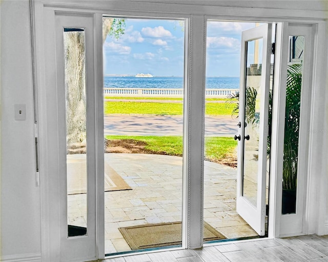 doorway to outside with a water view