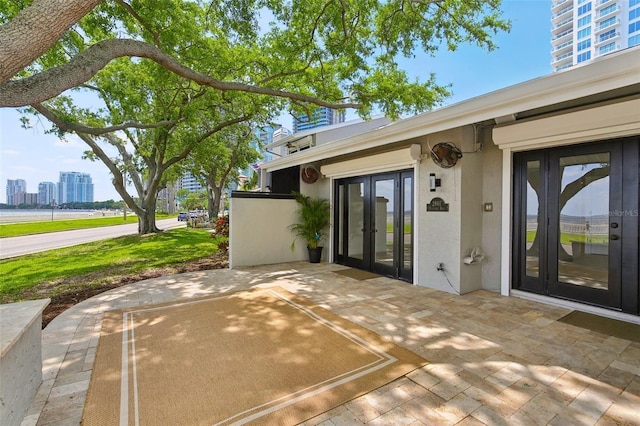 view of patio featuring french doors and a city view