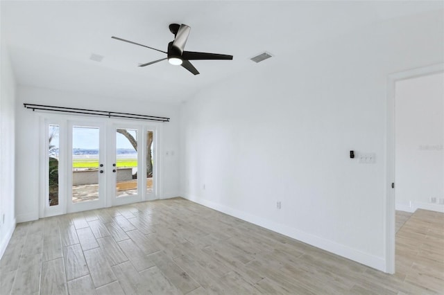 unfurnished room featuring baseboards, french doors, visible vents, ceiling fan, and light wood finished floors