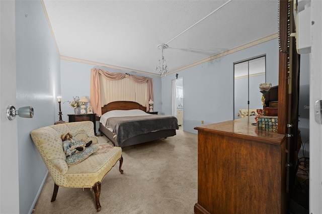 carpeted bedroom with ensuite bathroom, ornamental molding, and baseboards