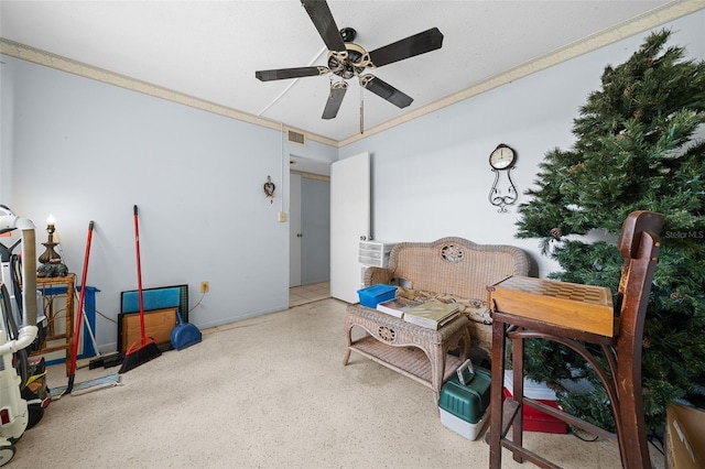 sitting room with speckled floor and a ceiling fan
