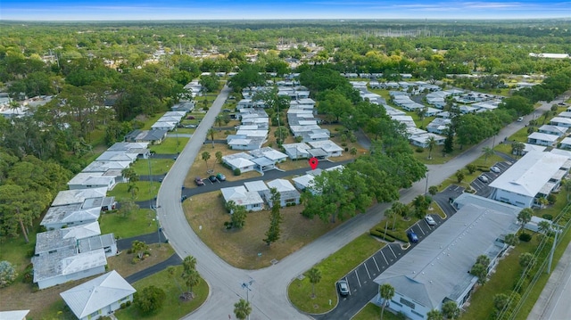 birds eye view of property with a residential view and a view of trees