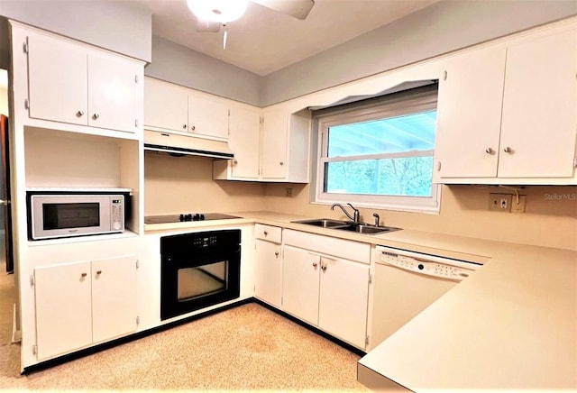 kitchen with light countertops, under cabinet range hood, a sink, a ceiling fan, and black appliances