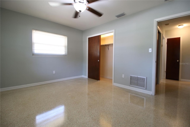 unfurnished bedroom featuring baseboards, visible vents, and speckled floor