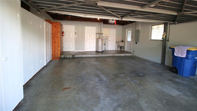 garage featuring water heater, a garage door opener, a sink, and electric panel