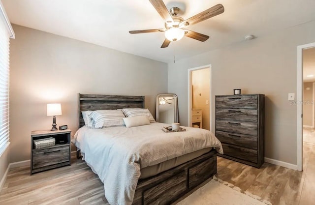 bedroom featuring light wood finished floors, baseboards, and a ceiling fan