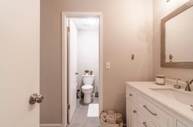 bathroom featuring toilet and vanity