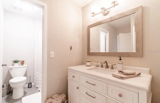 bathroom featuring toilet and vanity