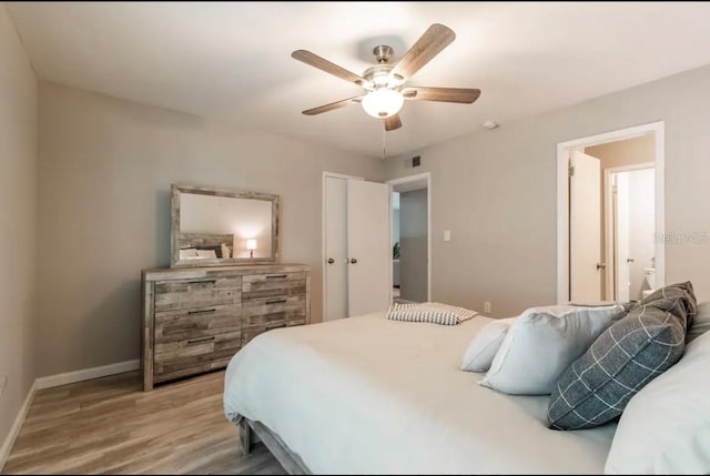 bedroom with baseboards, ceiling fan, visible vents, and light wood-type flooring
