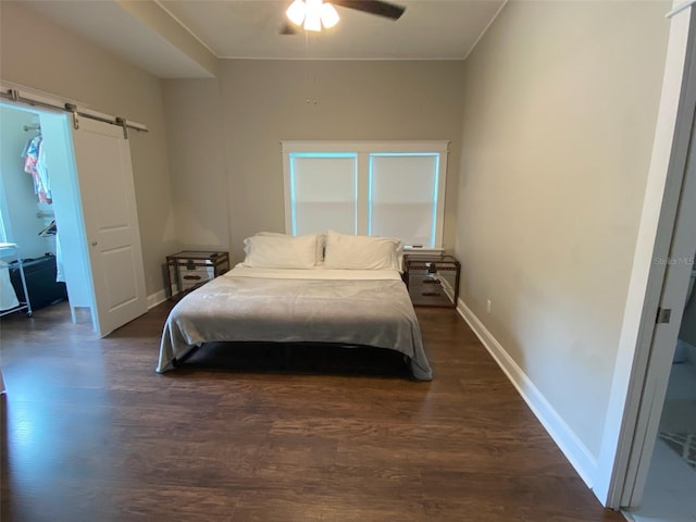 1515 E 31st Ave, Tampa, FL 33610 - bedroom with baseboards, a barn door, ceiling fan, and dark wood-type flooring