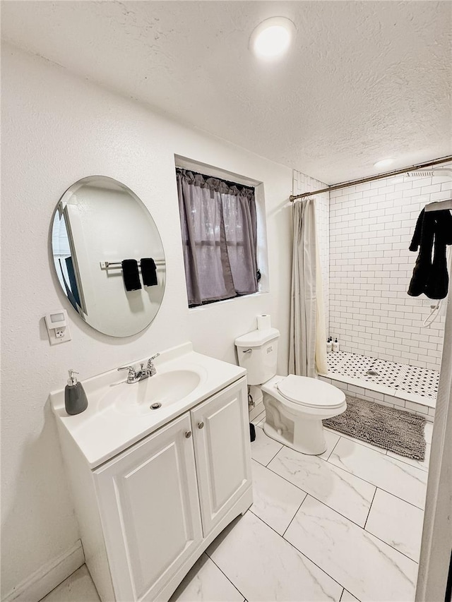 1515 E 31st Ave, Tampa, FL 33610 - bathroom featuring vanity, a tile shower, toilet, a textured ceiling, and marble finish floor