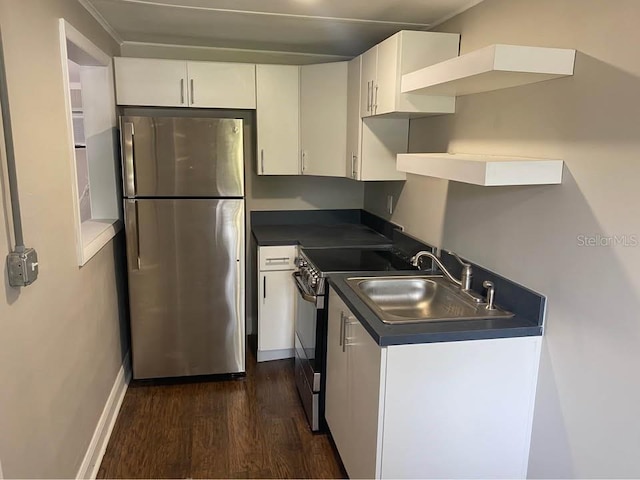 1515 E 31st Ave, Tampa, FL 33610 - kitchen featuring a sink, freestanding refrigerator, black range with electric cooktop, dark countertops, and white cabinets