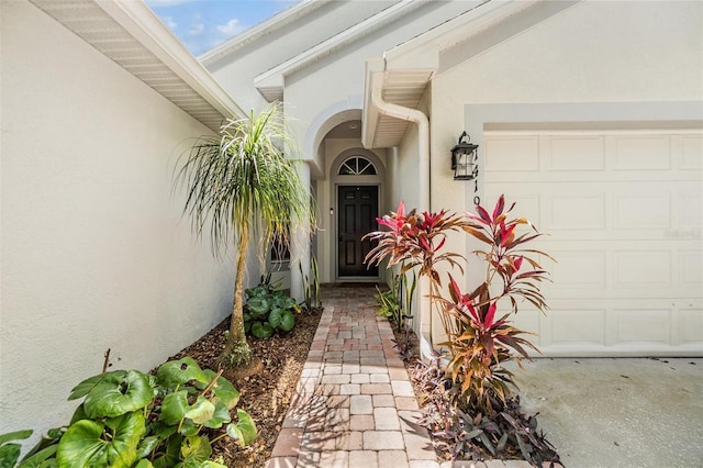 1419 Trail Boss Ln, Brandon, FL 33511 - doorway to property with stucco siding and an attached garage