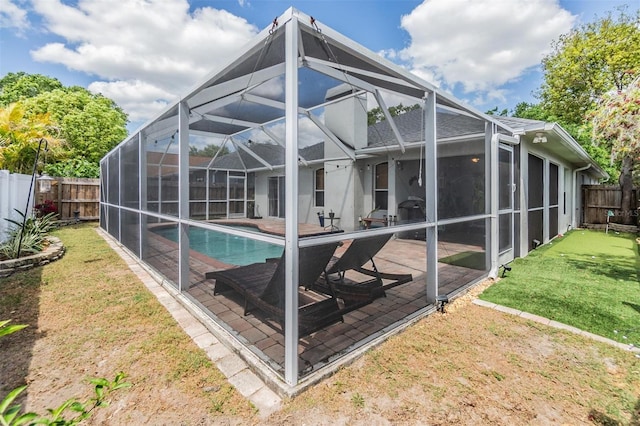 1419 Trail Boss Ln, Brandon, FL 33511 - rear view of property with a fenced backyard, a patio, and glass enclosure