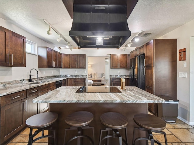 6241 Bayside Dr, New Port Richey, FL 34652 - kitchen with track lighting, exhaust hood, black appliances, a textured ceiling, and a sink