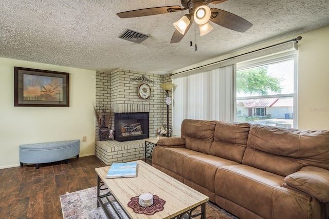 6831 Greenwich Ave, New Port Richey, FL 34653 - living area featuring a textured ceiling, ceiling fan, visible vents, a fireplace, and wood finished floors