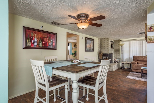 6831 Greenwich Ave, New Port Richey, FL 34653 - dining space featuring a textured ceiling, visible vents, a brick fireplace, ceiling fan, and wood finished floors