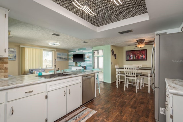 6831 Greenwich Ave, New Port Richey, FL 34653 - kitchen featuring dark wood-style floors, a sink, white cabinets, and appliances with stainless steel finishes