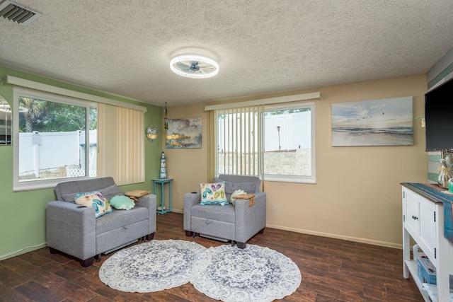 6831 Greenwich Ave, New Port Richey, FL 34653 - living area featuring baseboards, a textured ceiling, a wealth of natural light, and wood finished floors