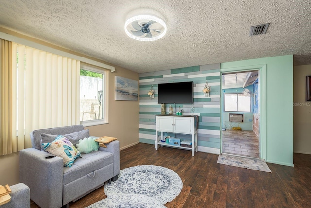 6831 Greenwich Ave, New Port Richey, FL 34653 - interior space with a textured ceiling, visible vents, baseboards, wood finished floors, and a ceiling fan
