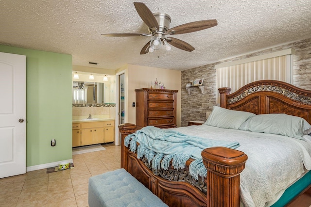 6831 Greenwich Ave, New Port Richey, FL 34653 - bedroom featuring a textured ceiling, light tile patterned flooring, a sink, connected bathroom, and visible vents