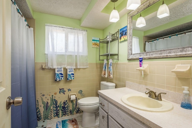 6831 Greenwich Ave, New Port Richey, FL 34653 - full bathroom featuring a wainscoted wall, toilet, vanity, a textured ceiling, and tile walls