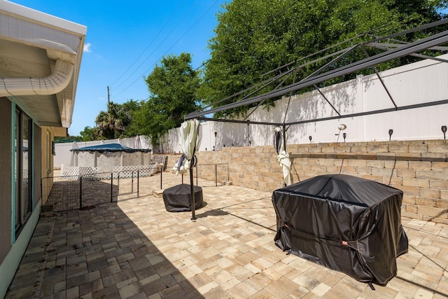 6831 Greenwich Ave, New Port Richey, FL 34653 - view of patio with a fenced backyard, area for grilling, and a fire pit