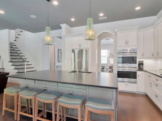 150 Chippewa Ave, Tampa, FL 33606 - kitchen with white cabinetry, a sink, and appliances with stainless steel finishes