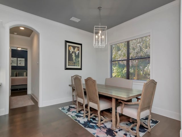 150 Chippewa Ave, Tampa, FL 33606 - dining room with a chandelier, dark wood finished floors, visible vents, arched walkways, and ornamental molding
