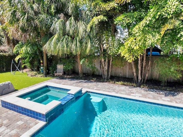 150 Chippewa Ave, Tampa, FL 33606 - view of swimming pool with a fenced backyard, a pool with connected hot tub, and a yard