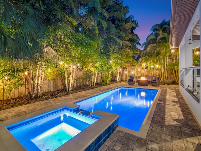 150 Chippewa Ave, Tampa, FL 33606 - pool at dusk with a fenced backyard, a pool with connected hot tub, and a patio area