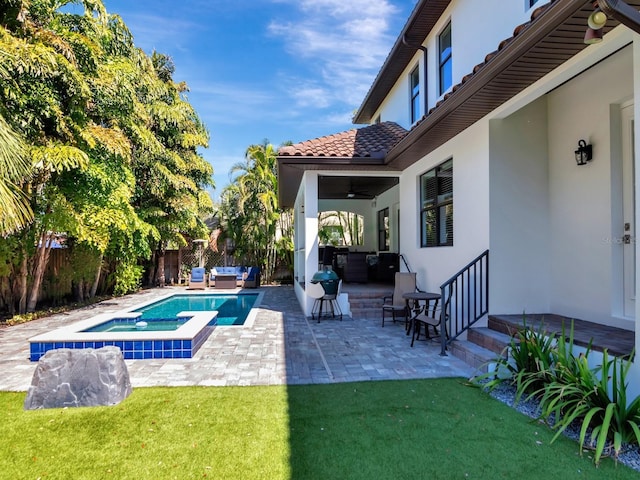 150 Chippewa Ave, Tampa, FL 33606 - view of pool with a patio, a fenced backyard, an outdoor living space, an in ground hot tub, and a lawn