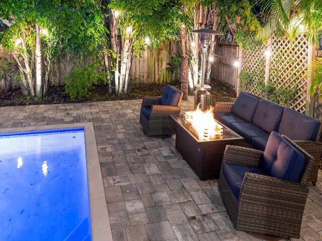 150 Chippewa Ave, Tampa, FL 33606 - view of patio featuring a fenced backyard, a fenced in pool, and an outdoor living space with a fire pit