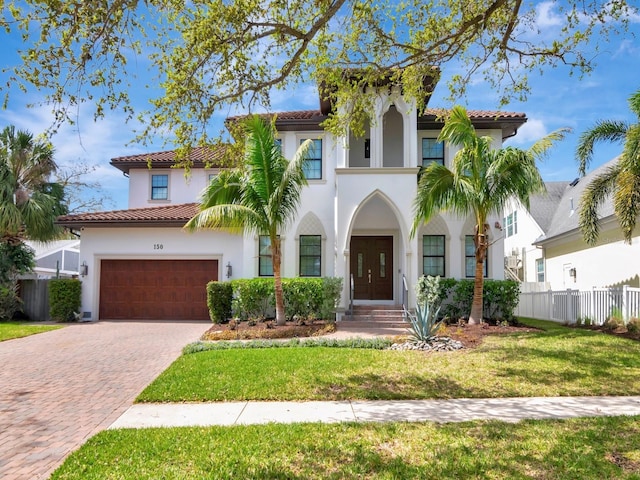 150 Chippewa Ave, Tampa, FL 33606 - mediterranean / spanish-style home featuring a tiled roof, decorative driveway, stucco siding, and fence