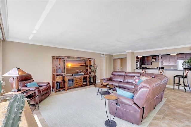 living area with crown molding, baseboards, and visible vents