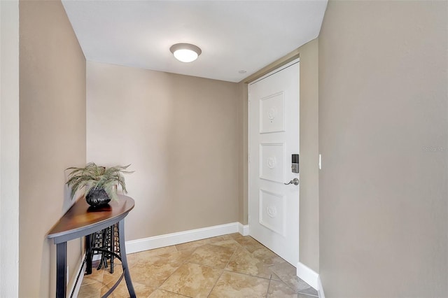 doorway to outside featuring baseboards