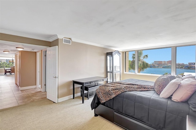 bedroom featuring baseboards, ornamental molding, visible vents, and light colored carpet