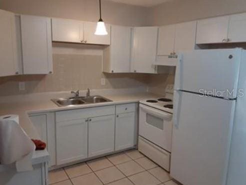 kitchen with light countertops, white cabinets, white appliances, a sink, and extractor fan
