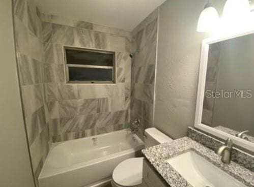 bathroom featuring shower / tub combination, toilet, and vanity