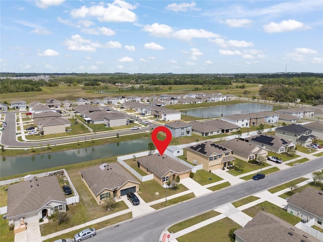 birds eye view of property featuring a water view and a residential view
