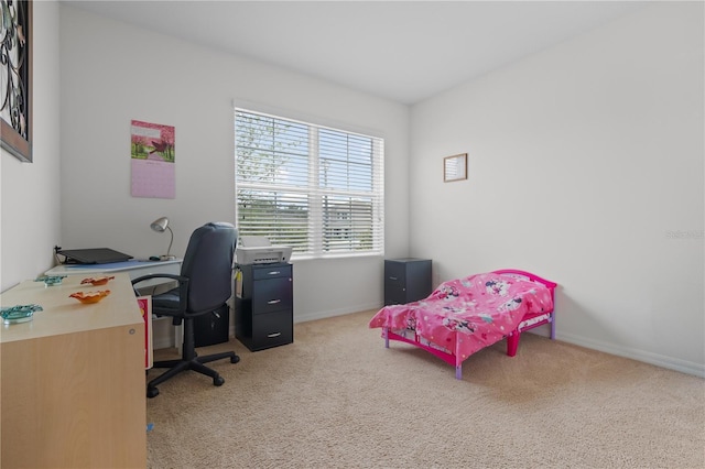 bedroom with light carpet and baseboards