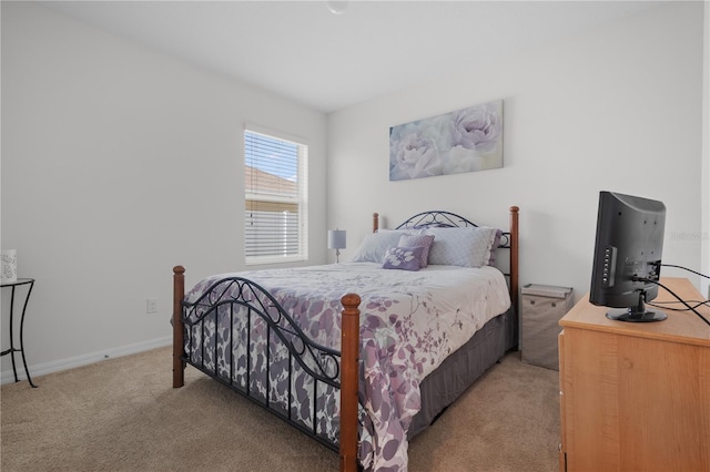 carpeted bedroom featuring baseboards