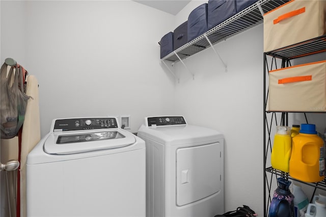 clothes washing area featuring washer and dryer and laundry area