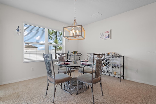 dining space featuring a wealth of natural light, carpet flooring, and an inviting chandelier