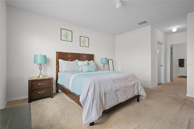 bedroom with visible vents, baseboards, and light colored carpet